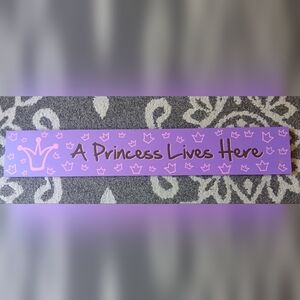 Purple 'A Princess Lives Here' Wall Sign
